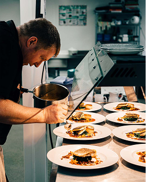 Chef preparing dishes at Le Blokk